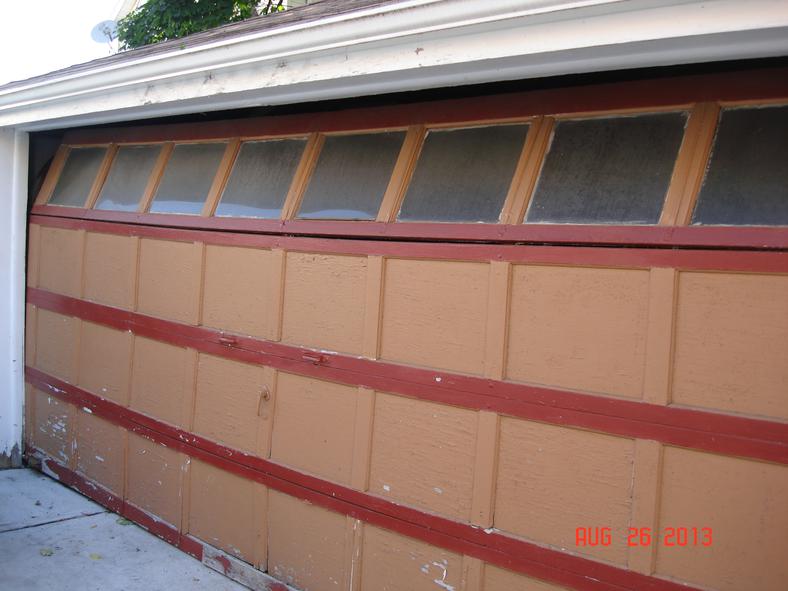 Old wood garage door with broken top section 