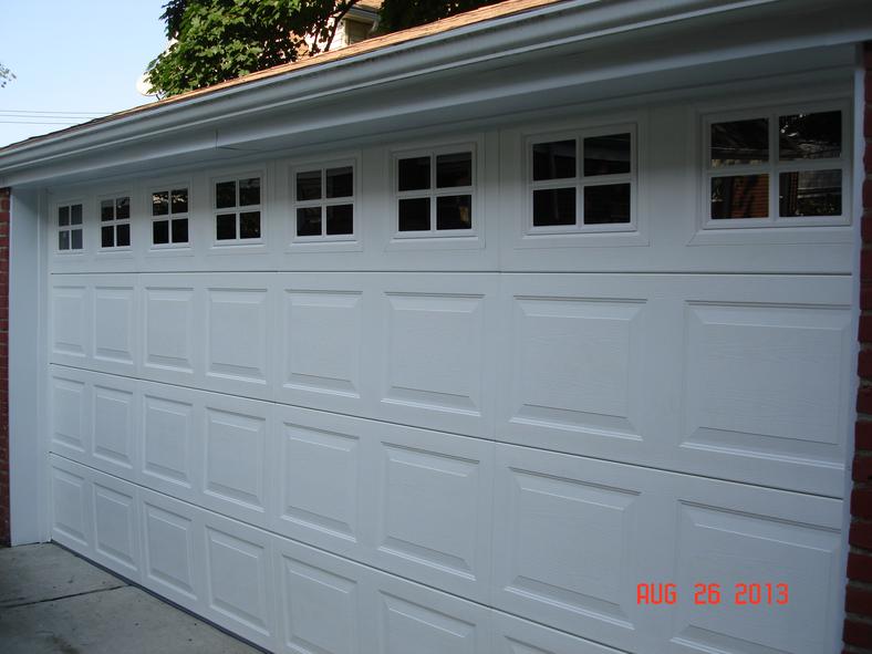 Installed a brand new vinyl garage door with window inserts and aluminum capping